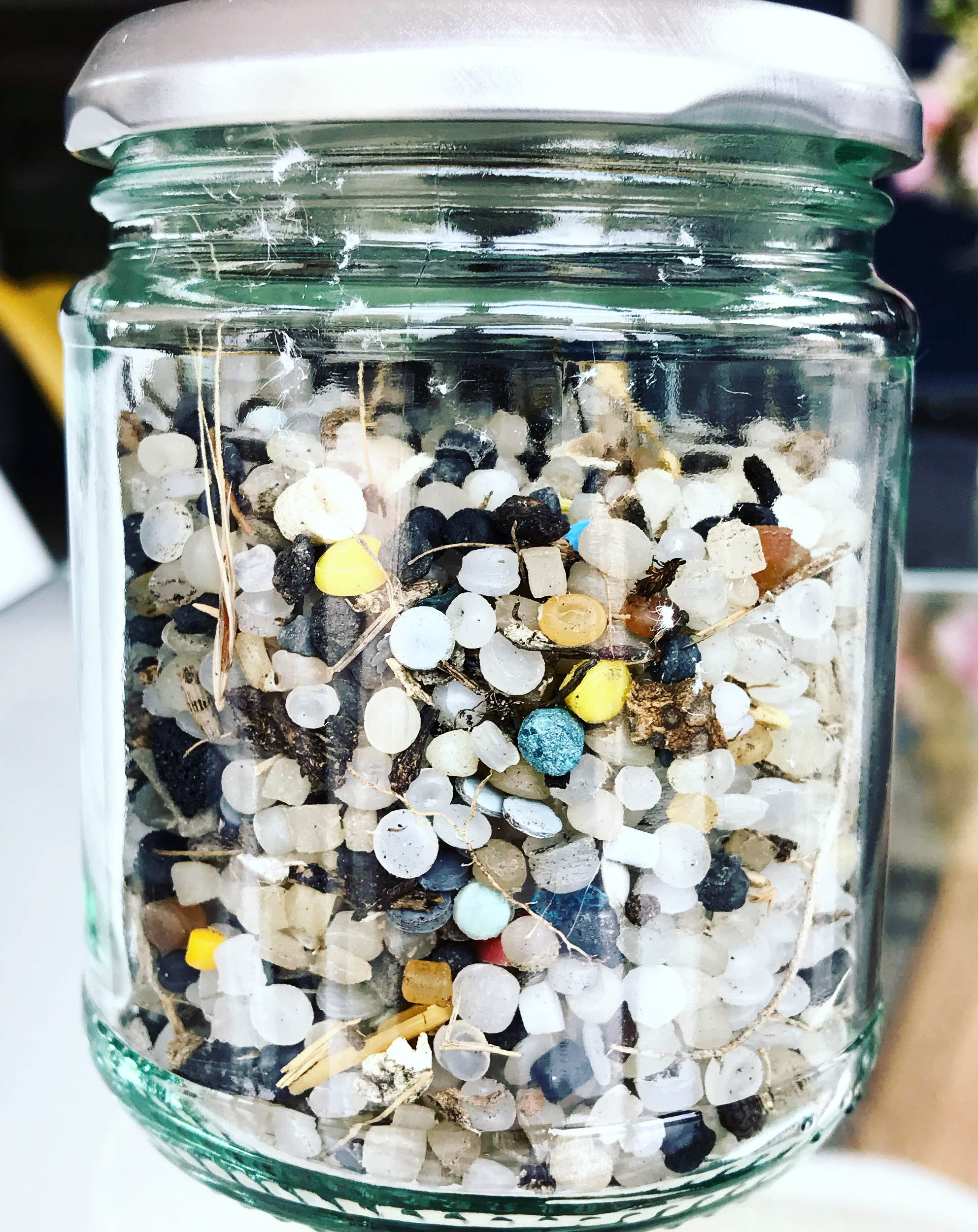 Jar of nurdles collected on a beach clean