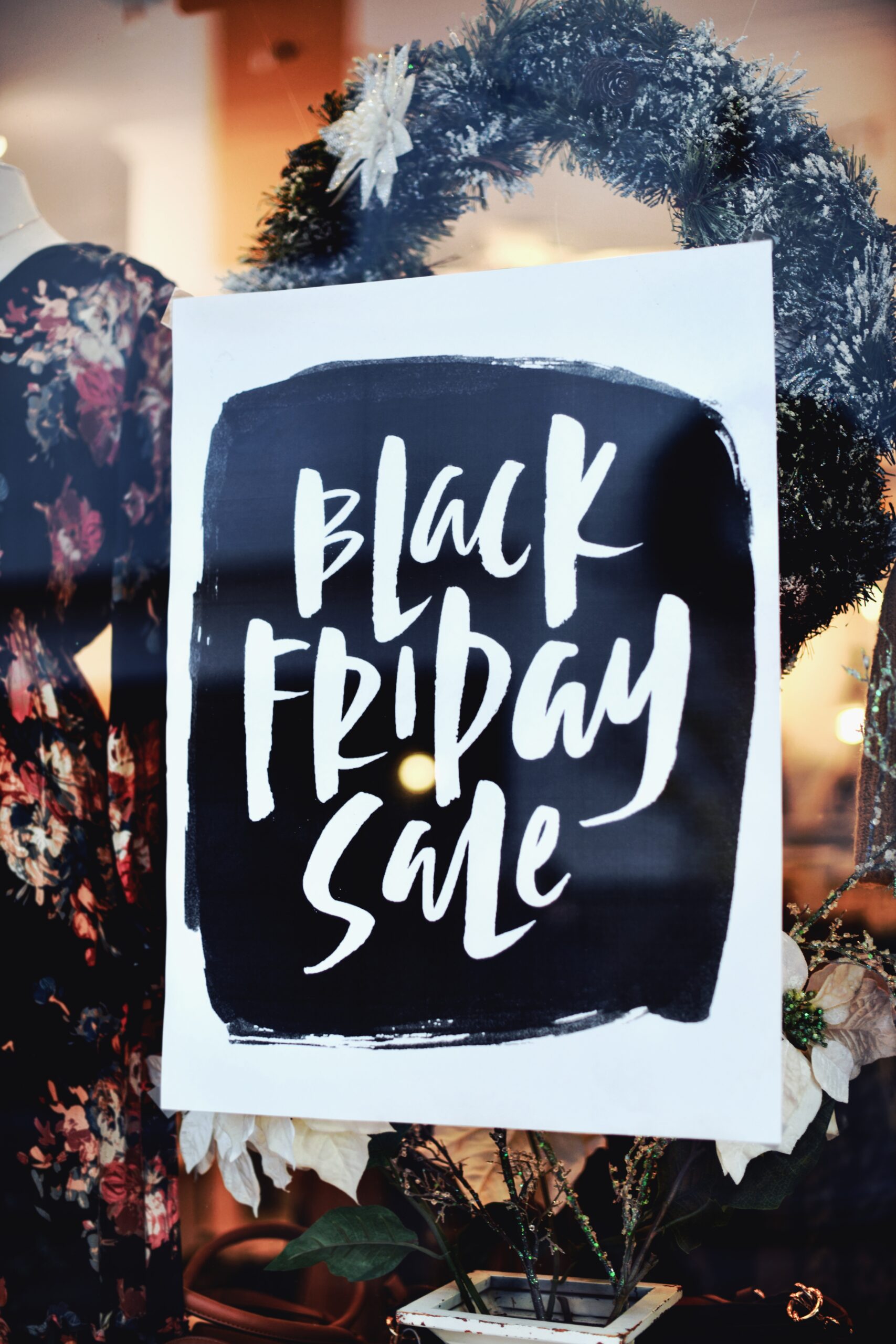 tim-mossholder-qh75QT91TfA-unsplash A photo by Tim Mossholder of a sign that reads Black Friday Sale in a shop window.