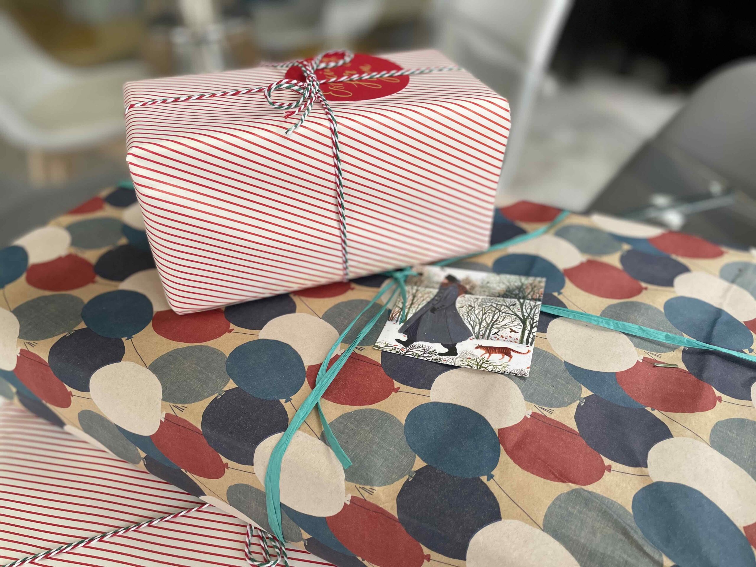 Plastic-Free Xmas Wrapping A photo of some Christmas Presents piled up with no plastic packaging.
