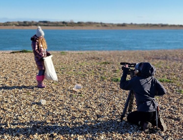 Billie on her annual NY beach clean in January 2024, being filmed by Sky News on the beach