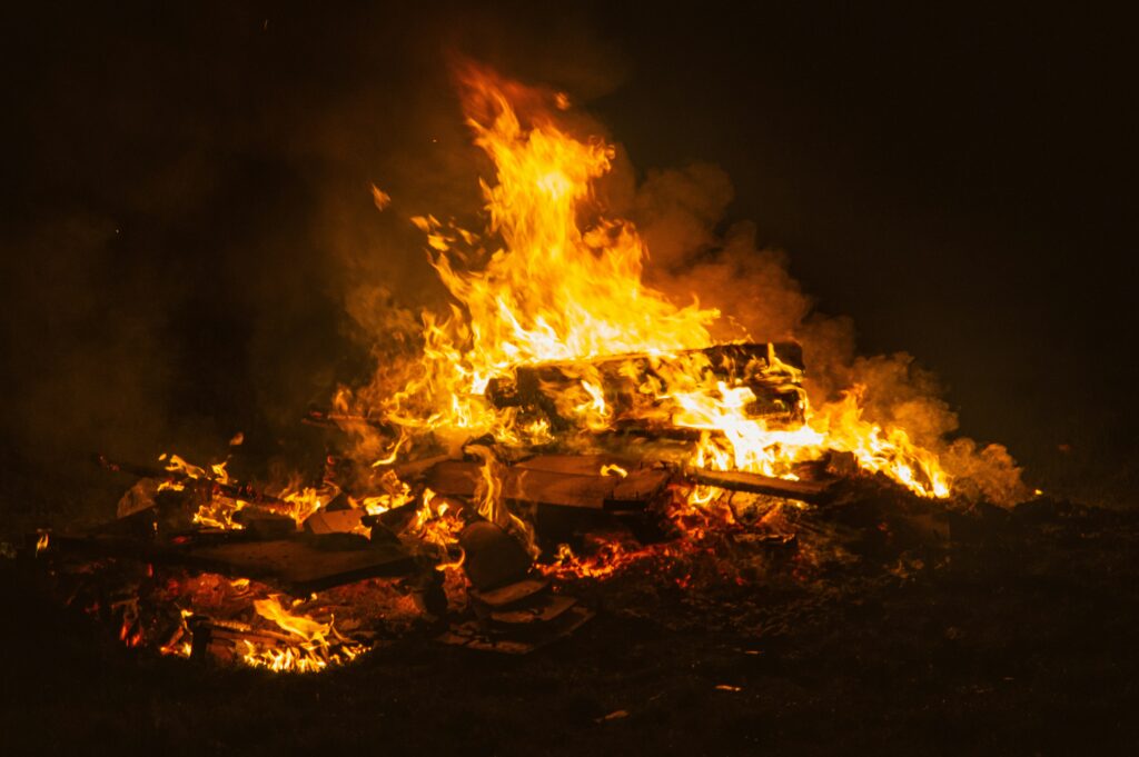 a photo of a bonfire in the dark from unsplash